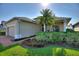Well-manicured home featuring brick driveway, lush lawn, and a mature palm tree at 124 Ashton Dr, Davenport, FL 33837