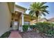 Covered porch with decorative pillars, seating area, and well-maintained landscaping at 124 Ashton Dr, Davenport, FL 33837