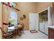 Bright eat-in kitchen features white tile flooring, wood table, and laundry closet with washer and dryer at 124 Ashton Dr, Davenport, FL 33837