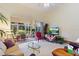 Bright living room with high ceilings, neutral carpet, and large windows showcasing outdoor views at 124 Ashton Dr, Davenport, FL 33837
