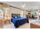 Spacious main bedroom featuring a king bed, ceiling fan, and a dedicated office space at 124 Ashton Dr, Davenport, FL 33837
