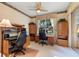 Home office featuring carpet floors, ceiling fan, bright windows, and a built-in desk at 124 Ashton Dr, Davenport, FL 33837