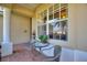 Cozy outdoor patio with seating area and views of the surrounding greenery at 124 Ashton Dr, Davenport, FL 33837