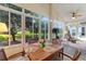 Outdoor patio features table, chairs, view of garden, and rocking chair seating area at 124 Ashton Dr, Davenport, FL 33837