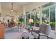Serene sunroom with ceiling fan, comfortable seating, and expansive windows overlooking the backyard at 124 Ashton Dr, Davenport, FL 33837