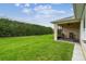 Spacious backyard features a well-maintained lawn and a screened-in patio at 1272 Bonita Canyon Dr, Poinciana, FL 34759