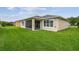 A large backyard with green grass and a screened-in patio area at 1272 Bonita Canyon Dr, Poinciana, FL 34759