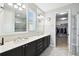 Bathroom featuring dual sinks, a walk-in closet, and a separate tiled shower for a luxurious experience at 1272 Bonita Canyon Dr, Poinciana, FL 34759