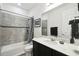 Neutral bathroom with tile shower/tub, dark cabinets, and granite countertop at 1272 Bonita Canyon Dr, Poinciana, FL 34759