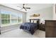 Cozy bedroom featuring a ceiling fan and a large window at 1272 Bonita Canyon Dr, Poinciana, FL 34759