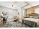 Comfortable bedroom with a wood-paneled accent wall, ceiling fan, and ample natural light at 1272 Bonita Canyon Dr, Poinciana, FL 34759
