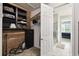 View of walk-in closet with wooden shelves and closet system, and bathroom entrance at 1272 Bonita Canyon Dr, Poinciana, FL 34759