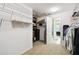 Walk-in closet with carpet flooring, wire shelving, and entrance to the bathroom at 1272 Bonita Canyon Dr, Poinciana, FL 34759