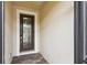 An elegant front door with decorative glass welcomes you, set against a neutral exterior with brick pavers at 1272 Bonita Canyon Dr, Poinciana, FL 34759