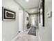 Bright entryway with tile flooring, decorative art, and access to the front door at 1272 Bonita Canyon Dr, Poinciana, FL 34759