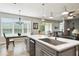 Beautiful kitchen with gray cabinets, center island and stainless appliances at 1272 Bonita Canyon Dr, Poinciana, FL 34759