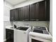 Well-organized laundry room boasts modern cabinets, a sink and new washer and dryer units at 1272 Bonita Canyon Dr, Poinciana, FL 34759