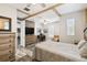 Comfortable main bedroom featuring wood accents, a ceiling fan, an ensuite, and a workspace at 1272 Bonita Canyon Dr, Poinciana, FL 34759