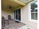 Relaxing outdoor patio with brick pavers, seating, a grill and sliding door access at 1272 Bonita Canyon Dr, Poinciana, FL 34759