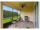 Screened-in patio with brick flooring, ceiling fan, grill, and outdoor seating at 1272 Bonita Canyon Dr, Poinciana, FL 34759