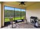 Relaxing screened-in patio featuring brick pavers, two chairs, table, and a grill at 1272 Bonita Canyon Dr, Poinciana, FL 34759
