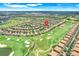 Community aerial view featuring a golf course and the neighborhood layout at 1300 Island Green St, Davenport, FL 33896