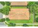 Overhead view of a single-story home showcasing its tile roof, manicured lawn, and proximity to neighboring houses and streets at 1300 Island Green St, Davenport, FL 33896