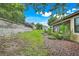 Landscaped backyard featuring a screened lanai, providing a private outdoor living space at 1300 Island Green St, Davenport, FL 33896
