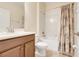 Bathroom featuring a vanity, toilet, and a shower with a decorative curtain at 1300 Island Green St, Davenport, FL 33896
