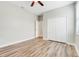 Spacious bedroom showcasing laminate floors, a ceiling fan, and a double door closet at 1300 Island Green St, Davenport, FL 33896