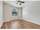 Comfortable bedroom with laminate floors, a ceiling fan, and a bright window view at 1300 Island Green St, Davenport, FL 33896