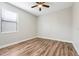 Bedroom with laminate floors, a ceiling fan, and large bright window at 1300 Island Green St, Davenport, FL 33896