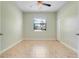 Bright bedroom with tile floors, ceiling fan, and a window providing natural light at 1300 Island Green St, Davenport, FL 33896