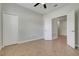 Bright bedroom featuring tile floors, a ceiling fan, closet, and doorway to another room at 1300 Island Green St, Davenport, FL 33896