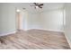 Spacious bedroom featuring modern vinyl floors, a ceiling fan, and neutral paint at 1300 Island Green St, Davenport, FL 33896