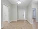 Bright foyer with neutral tile flooring, white walls, and multiple doorways at 1300 Island Green St, Davenport, FL 33896