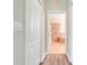 Hallway leading to bathroom with a linen closet, and modern flooring at 1300 Island Green St, Davenport, FL 33896