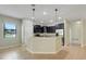 Kitchen with granite countertops, a large peninsula, dark cabinets, and stainless steel appliances at 1300 Island Green St, Davenport, FL 33896