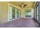 Cozy, screened lanai with brick flooring and views of the lush, green yard at 1300 Island Green St, Davenport, FL 33896