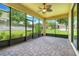 Enclosed lanai with brick pavers and view of the beautifully landscaped backyard at 1300 Island Green St, Davenport, FL 33896