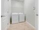 Practical laundry room with washer, dryer, and convenient overhead shelving at 1300 Island Green St, Davenport, FL 33896