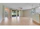 Expansive living room with tile floors, a ceiling fan, and access to the outdoors through sliding glass doors at 1300 Island Green St, Davenport, FL 33896