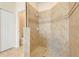 Modern tile shower featuring a built-in soap holder and tiled walls at 1300 Island Green St, Davenport, FL 33896