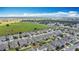 Aerial view of a sprawling residential area with modern gray homes, green spaces, and a clear view of the horizon at 140 Trinity Ridge Cir, Davenport, FL 33897