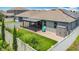 Aerial view of a backyard with a covered patio, artificial turf, and privacy fence, offering a private outdoor retreat at 140 Trinity Ridge Cir, Davenport, FL 33897