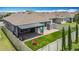 Aerial view of a backyard featuring a covered patio, lush artificial turf, and a secure privacy fence, perfect for outdoor activities at 140 Trinity Ridge Cir, Davenport, FL 33897