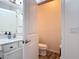 Powder room with a pedestal sink and an open door to the toilet room at 140 Trinity Ridge Cir, Davenport, FL 33897