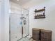 Bathroom featuring glass enclosed shower with white tile surround and industrial shelving at 140 Trinity Ridge Cir, Davenport, FL 33897