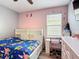 bedroom with pink and gray walls, ceiling fan, desk and bed with character linens at 140 Trinity Ridge Cir, Davenport, FL 33897