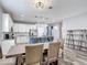 Dining area adjacent to an open kitchen has natural lighting and tile floors at 140 Trinity Ridge Cir, Davenport, FL 33897